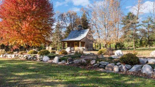 Adorable Garden Shed Getaway. Beautiful boulder landscaping.