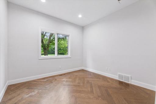 Home office with chevron floor detailing.