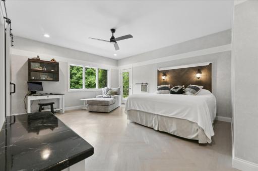 Primary Suite - Walk out to deck, overlooking backyard and pool.