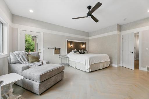 Built in headboard with independant reading sconces. Laundry chute with custom barndoor style, herringbone wood flooring.