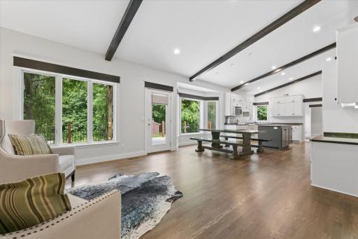 Vaulted Ceilings with Exposed Beams. Large windows overlooking the expansive deck and pool below.