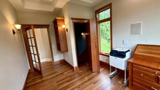 : Ingenious design on display. This angle highlights the hidden bookcase door in the open position, unveiling a dedicated, lit staircase that connects the main level to the lower level.