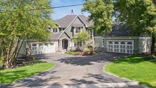 This home has two finished, heated 2-car garages w/epoxy floors, 10'ceilings, full waincoting, & built-in storage. The north garage has an EV charging station & the south garage has a workbench, ski lockers & the main 200-amp electrical panel.
