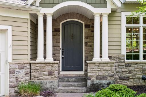 : Welcome home! The beautiful covered front porch creates a grand and inviting first impression.