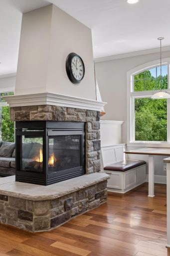 The ultimate ambiance. Cozy up to the stunning 3-sided gas fireplace, designed to bring warmth and a sophisticated glow to both the formal living room and the kitchen simultaneously.