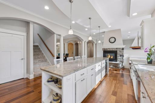 Perfectly connected! This view showcases the stairs leading to the upper level bedrooms, alongside the entry down to an incredible lower-level family room designed for ultimate entertaining.