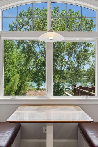 Enjoy spectacular views from your kitchen banquette. The table has a custom inlay of Lake Elmo adding to the homes charm.