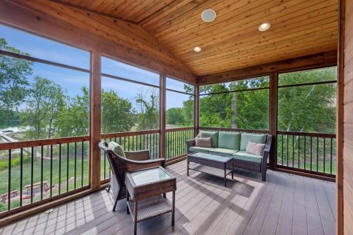 The perfect lakeside retreat! This gorgeous screened porch features maintenance-free Trex decking, a vaulted ceiling with a fan, recessed lights, and surround sound. Step outside to your new, built-in Lion Premium grill with a rotisserie.