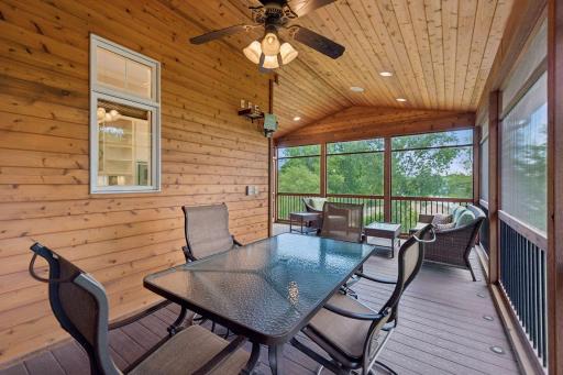 Outdoor living at its finest! This large screened porch (18'3" x 23'10") easily accommodates both a dining & sitting area. Rich tongue & groove walls pair beautifully with the vaulted ceiling, Trex decking, ceiling fan, & ready-to-go TV mount.