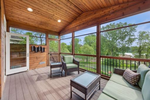 Seamless summer hosting! This view highlights just how close the screened porch sits to the kitchen, with a direct door leading straight to the outdoor cooking station and its brand-new, built-in Lion Premium grill with rotisserie.