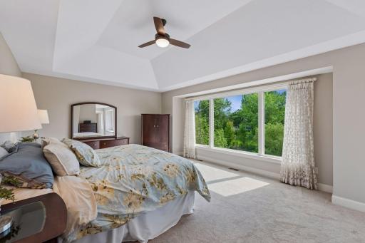 Welcome upstairs! Discover three spacious bedrooms, two bathrooms, a handy laundry room, two versatile bonus rooms, and plush new carpet. The private primary suite steals the show with a tray ceiling, a walk-in closet, and gorgeous lake views.