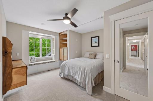 A dream room! Includes a stunning, handmade walnut and maple desk, a built-in window reading seat, a ceiling fan, a walk-in closet, surround sound and a custom alcove designed to perfectly frame bunk beds with individual reading lights.