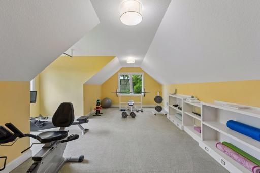 Massive versatility! This spacious bonus room features Cape Cod ceilings, built-in shelving, and lake views.