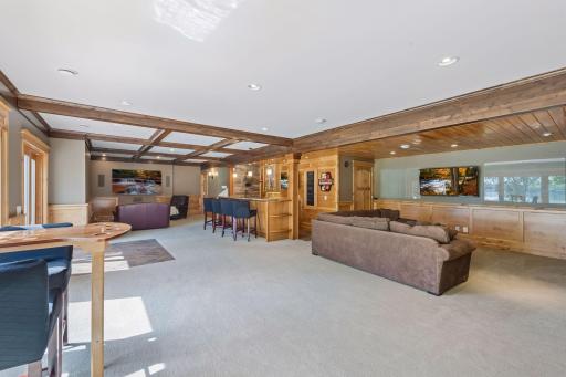 The ultimate entertainer's dream! Accessible via the kitchen stairs or a fun, hidden wall door, this massive (53' x 28'5") family room offers endless space. Includes a dedicated game zone, a cozy media lounge, and a premium built-in wet bar.