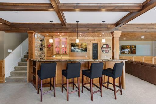A closer look at the incredible artistry! Highlights the solid alder and walnut handmade cabinetry, plus the ultra-convenient layout that allows for quick trips upstairs to the kitchen.