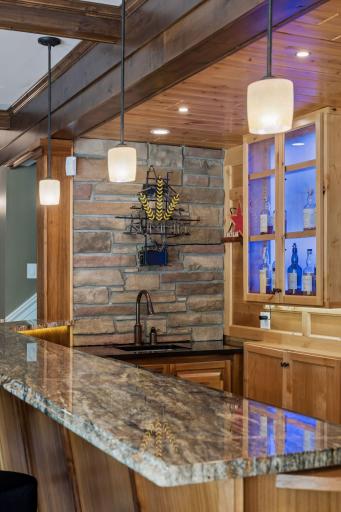 Serve your guests in style! This premium bar setup includes every amenity a host could want: a full dishwasher, a beverage fridge, a built-in ice maker, and a bar sink. Entertaining has never been this effortless.