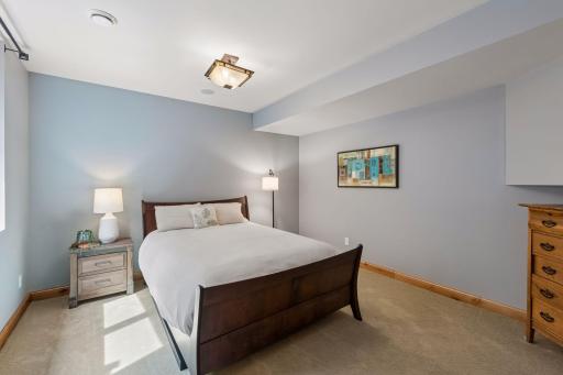 Comfort meets privacy. This large fourth bedroom offers an oversized egress window and excellent under-stairs storage. Guests will love the private 3/4 ensuite, featuring a modern ceramic trough sink and a glass-enclosed shower.