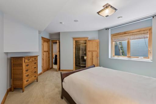 Another view of the fourth bedroom showcasing the private 3/4 ensuite bathroom.