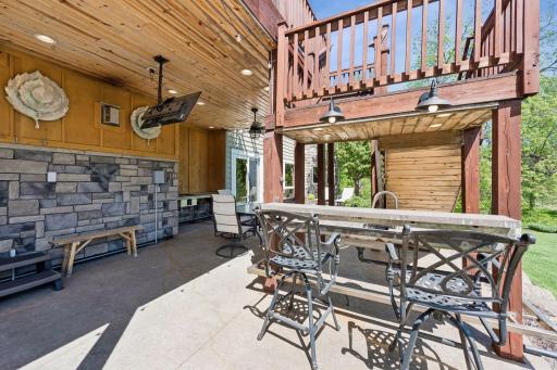 The ultimate post-lake hangout! Step off the water and onto this stamped concrete patio, fully equipped for lake life with a built-in bar, two working sinks for cleaning the catch of the day, a shaded knotty pine ceiling, and hot tub wiring.