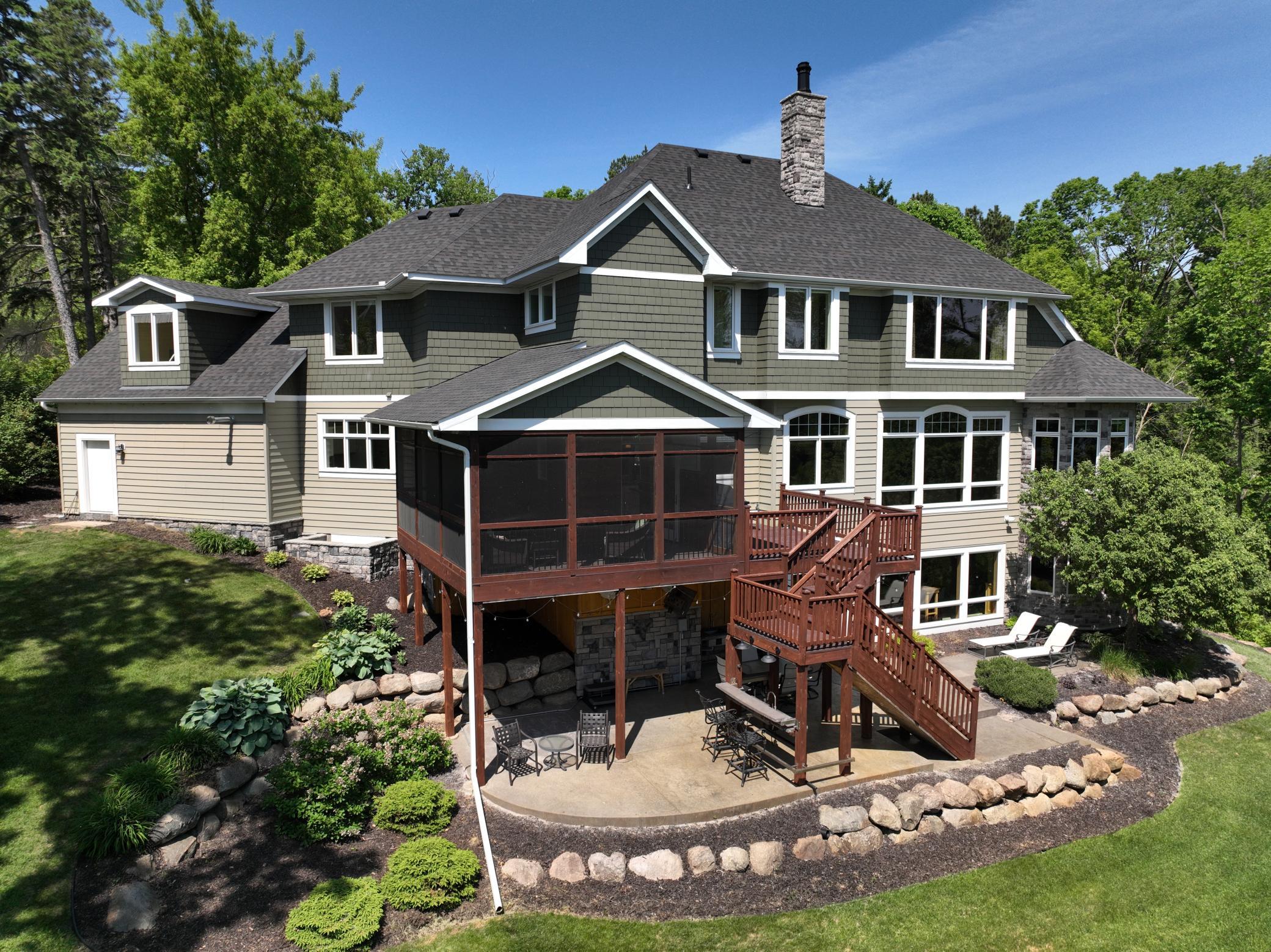 Closer view of the back of the home and the professional landscaping.