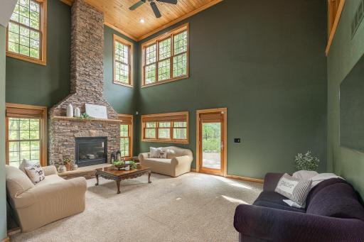 Living room with floor to ceiling stone fireplace