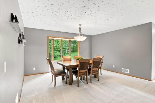 Dinning area with a bay window that looks into the backyard