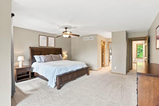 View of the primary bedroom looking towards the primary vanity area, walk-in closet and primary bathroom