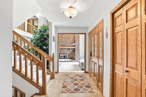 View of the entry way from standing in the kitchen. Front door on the right opens to the stairway.