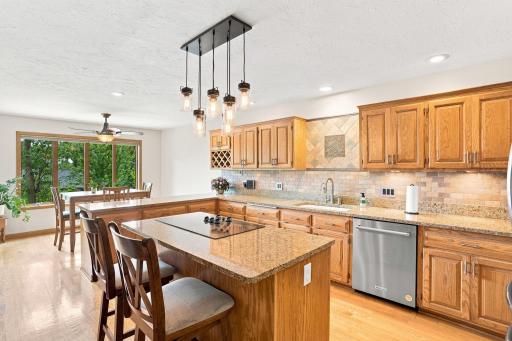 Kitchen with granite counter tops and a cooktop built into the island
