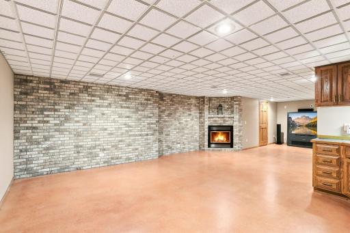 View of recreation room in lower level with gas burning fire place