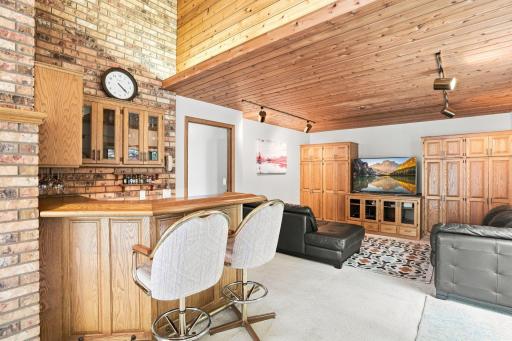Family room with built in storage and wet bar area