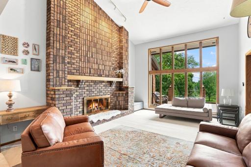 Living room with large windows that let in plenty of natural light and looks out to the front porch