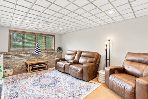 Lower level family room that has windows that allows in natural light
