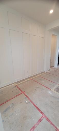 Custom wall paneling in the foyer sets the tone for what's to come in this highly upgraded model home.