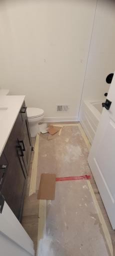 This full bathroom serves as a convenience to the two main level guest rooms, as well as the entire household.