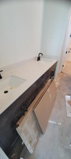 Well-appointed private bath designed for everyday comfort and functionality, featuring a large linen closet, private water closet, extra large shower, and natural lighting.