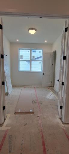 This main level guest room has beautiful glass doors which also make it the ideal room for a sophisticated library or cozy parlor.