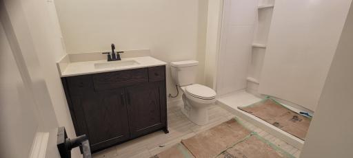Full lower-level bath adds convenience for visiting guests and entertaining needs.