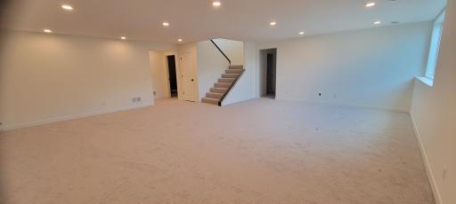 The professionally finished lower level adds exceptional recreation, hobby and secondary living space, and even features a wet bar rough-in for ultimate entertaining possibilities!