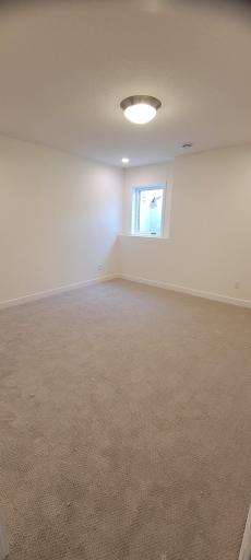 Private lower-level bedroom ideal for guests or multigenerational living.