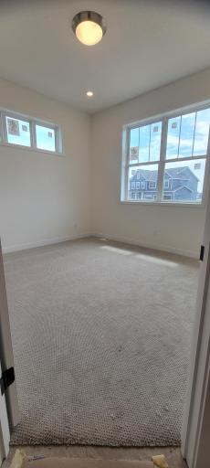 Versatile front guest room is perfect for a home office, library, music room or hobby room.