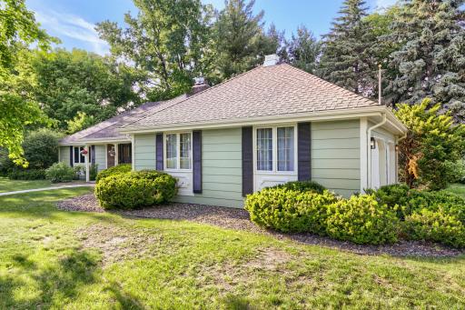 Positioned on a desirable corner lot, this beautifully updated home offers exceptional curb appeal and a private, park-like setting. The attractive side-load garage enhances the home's architectural appeal, creating a clean elegant front elevation.