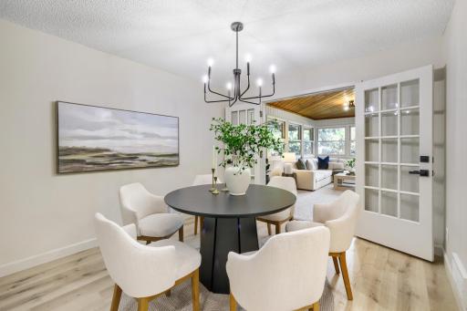 Beautiful French doors open to the adjacent sunroom, allowing natural light to flow throughout the space while creating a seamless connection between indoor and outdoor living.