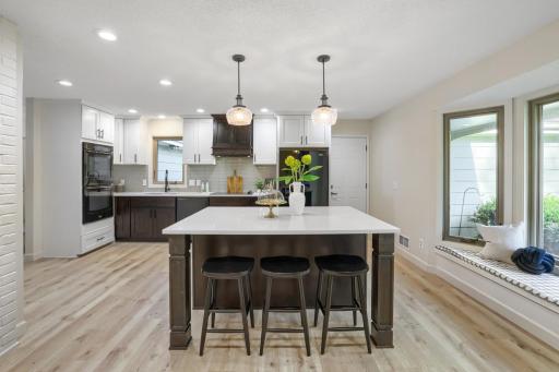 Anchored by a massive center island with gleaming quartz countertops and ample seating, this space is destined to become the gathering place for family and friends.