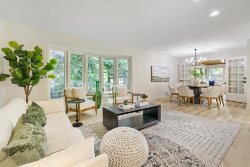 Seamlessly connected to the adjacent dining and kitchen areas, the open-concept layout offers exceptional flow for both everyday living and entertaining.