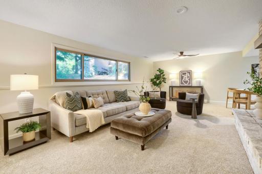 The expansive walkout lower-level family room offers an incredible amount of living and entertaining space while maintaining a warm and inviting feel. Large daylight windows fill the space with natural light creating a bright and airy atmosphere