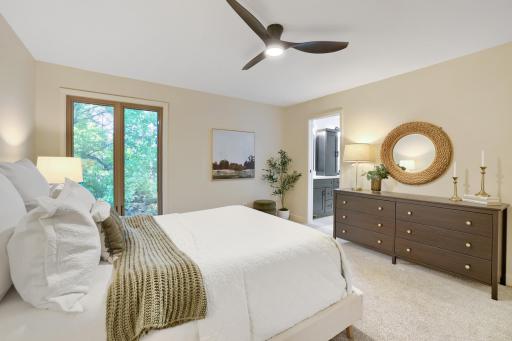 The primary suite features direct access to a stunning remodeled ensuite bathroom, creating a true private retreat. The generous layout easily accommodates additional seating or a reading nook, making the space feel both luxurious and functional.