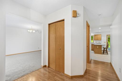 Foyer opens to living room on left, kitchen ahead, and stairs going up to the right
