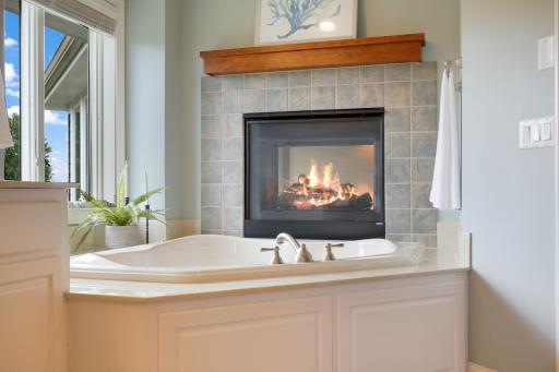 The cozy fireplace to enjoy during a relaxing bath in the large soaking tub
