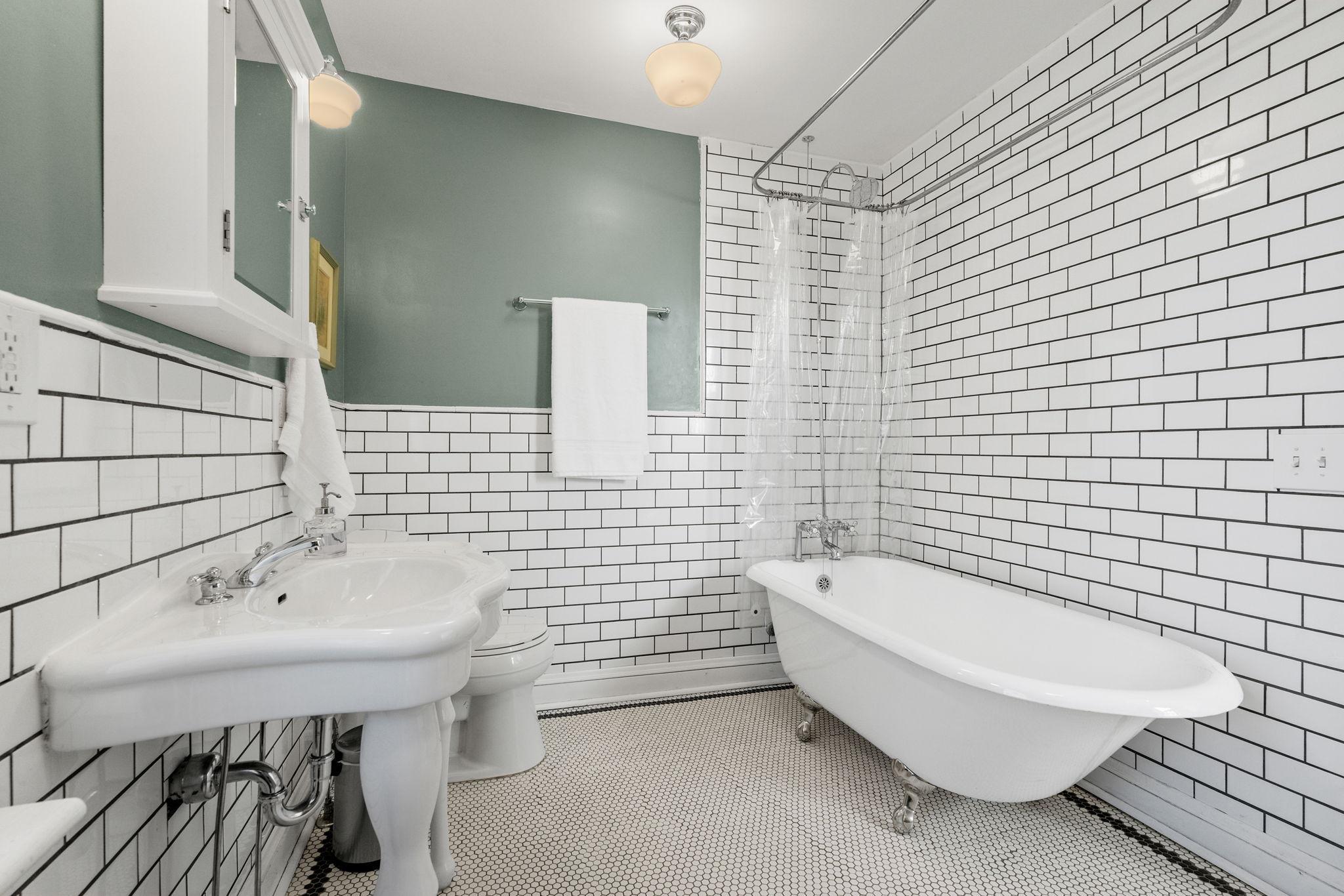 Charming tile floor and clawfoot tub